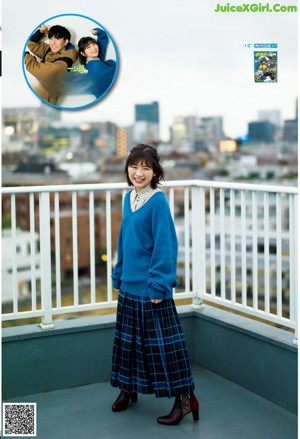 A woman in a white shirt is looking out a window.