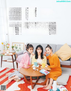 A group of women sitting around a table in a living room.