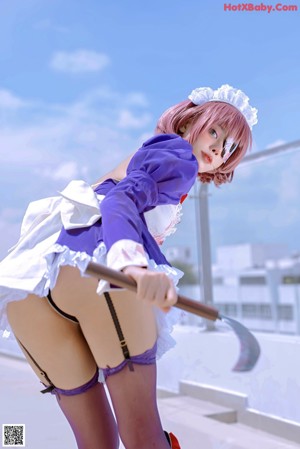 A woman dressed as a nurse holding a knife.