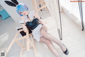 A woman sitting on top of a white chair.