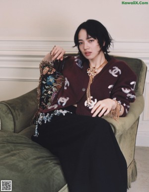 A woman sitting on a chair in a room.